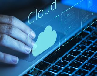 Woman scrolling on a laptop